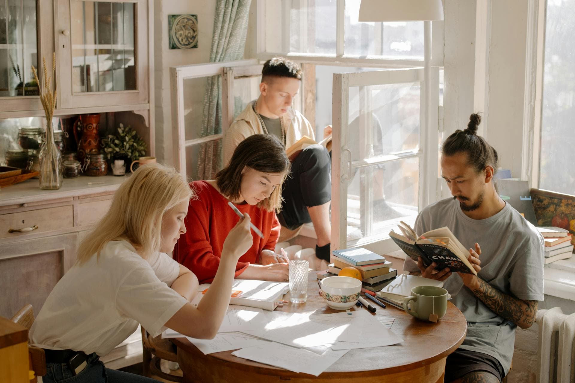 Study group working together at a table with books